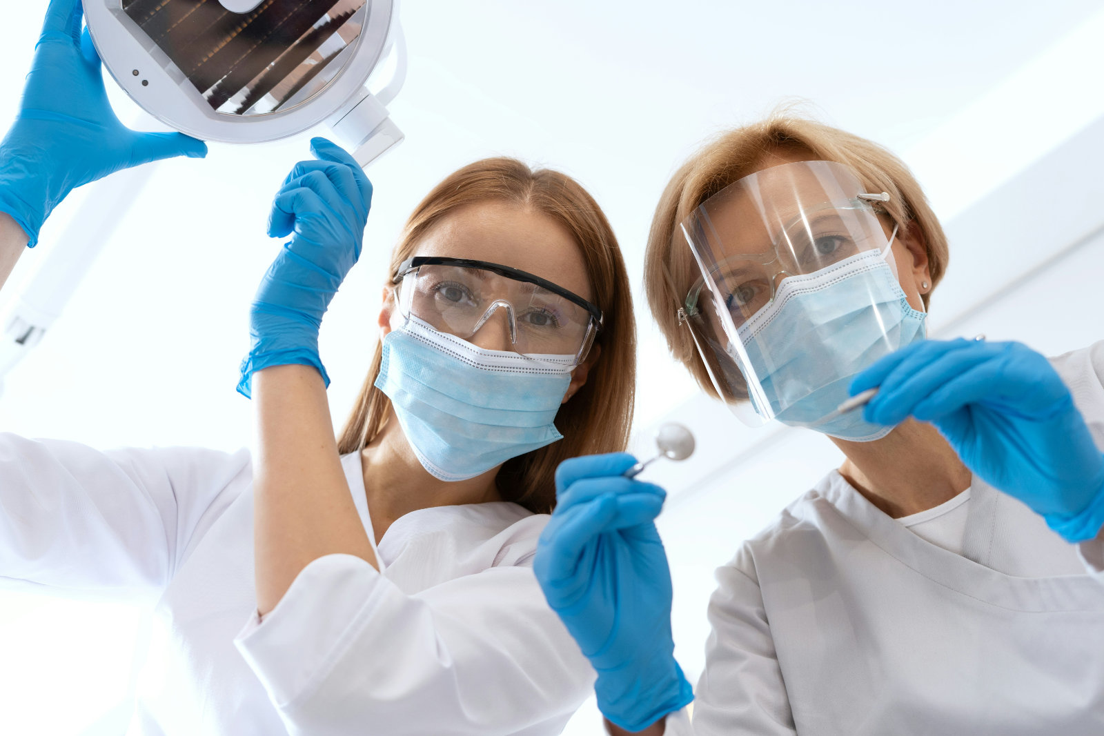 Two dentists prepare for a procedure