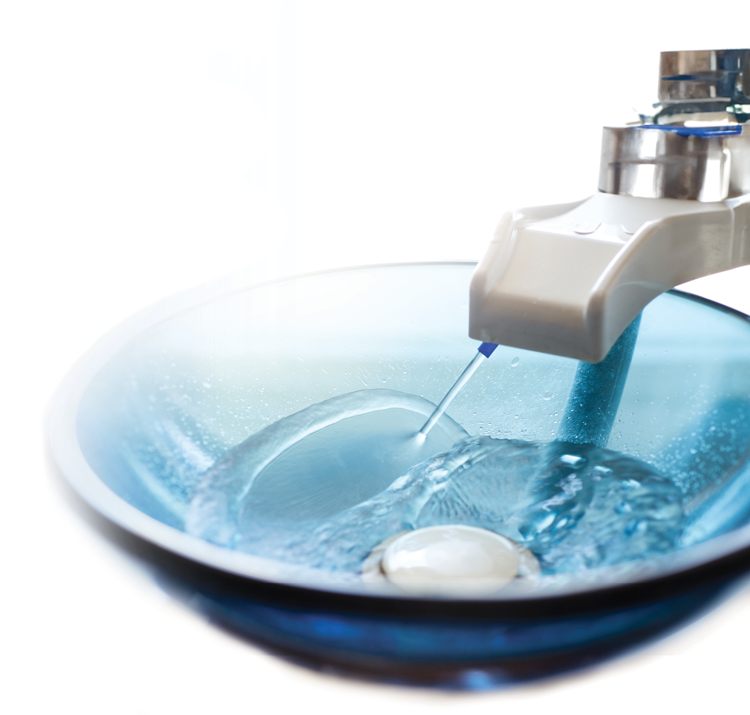 water flowing out of a faucet and on to a sink bowl