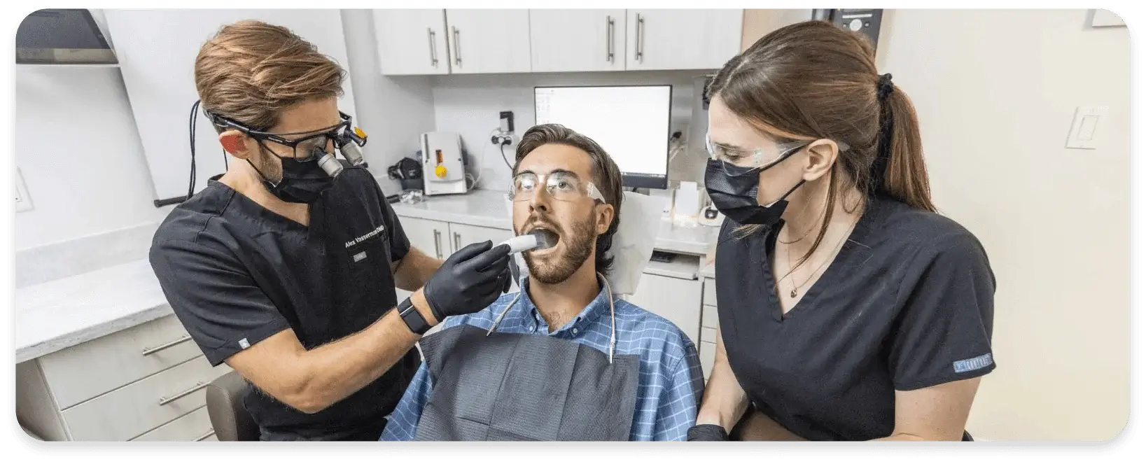 dentist and assistant working on patient with dryshield