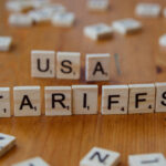 Scrabble tiles spell out USA and Tariffs