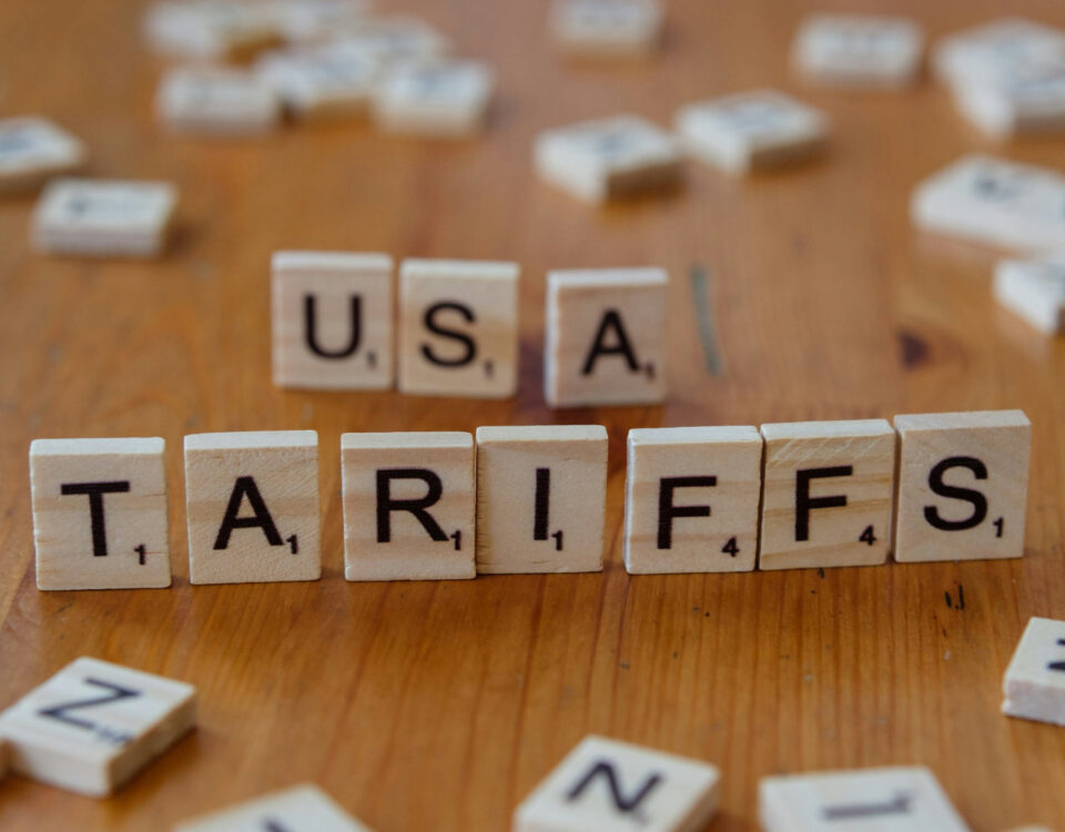 Scrabble tiles spell out USA and Tariffs