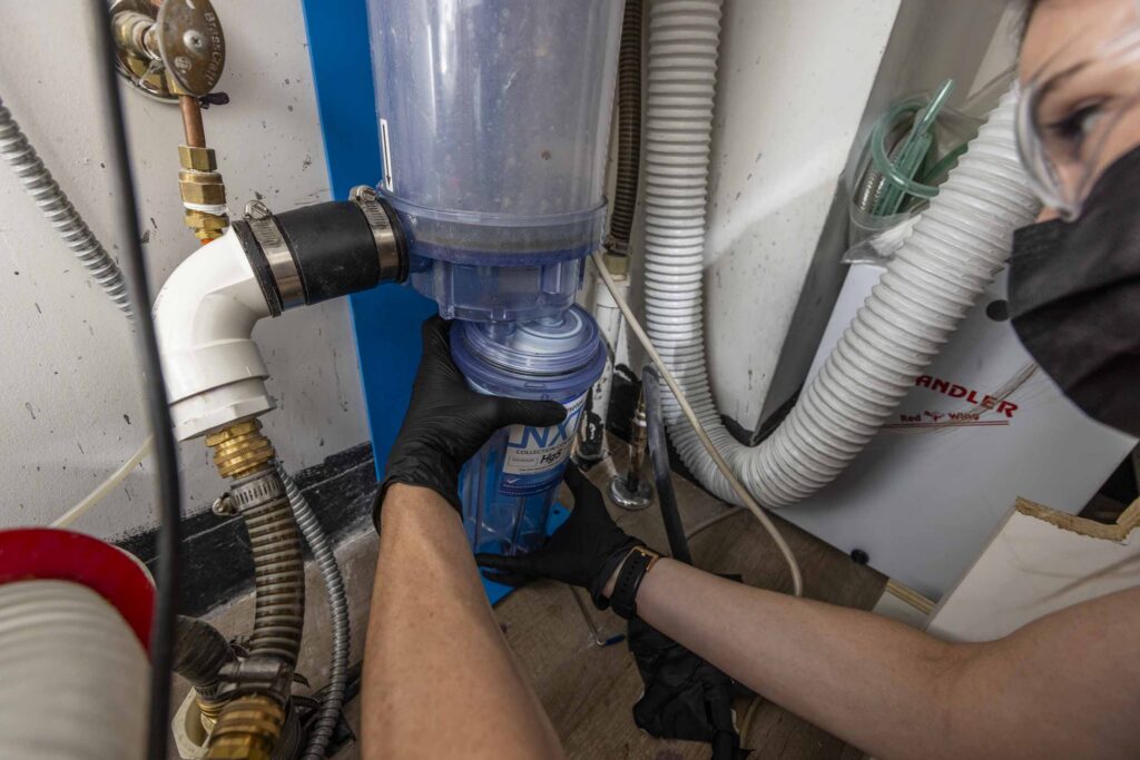 dental assistant replacing an amalgam separator container